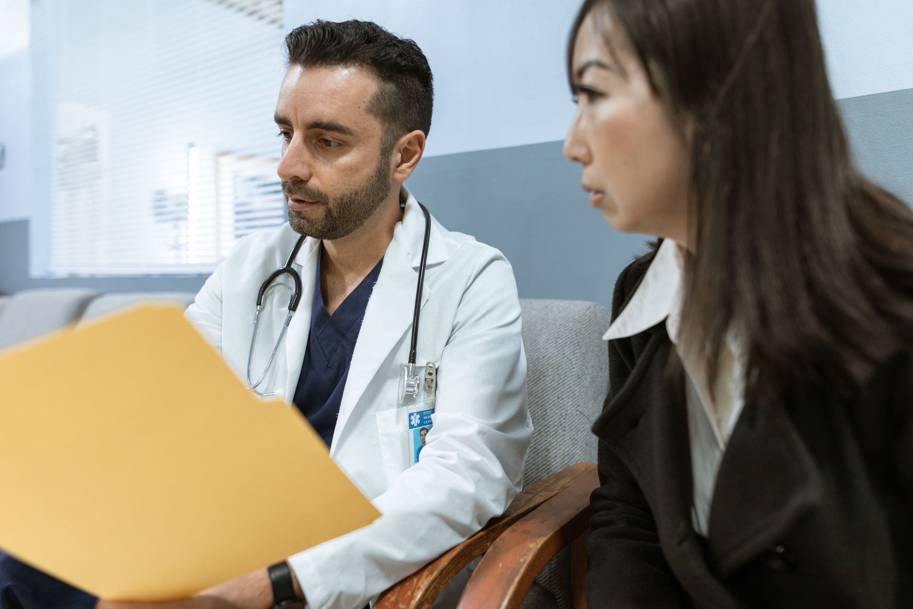Nurse practitioner reviewing a patient's health history during a primary care visit in Northern California